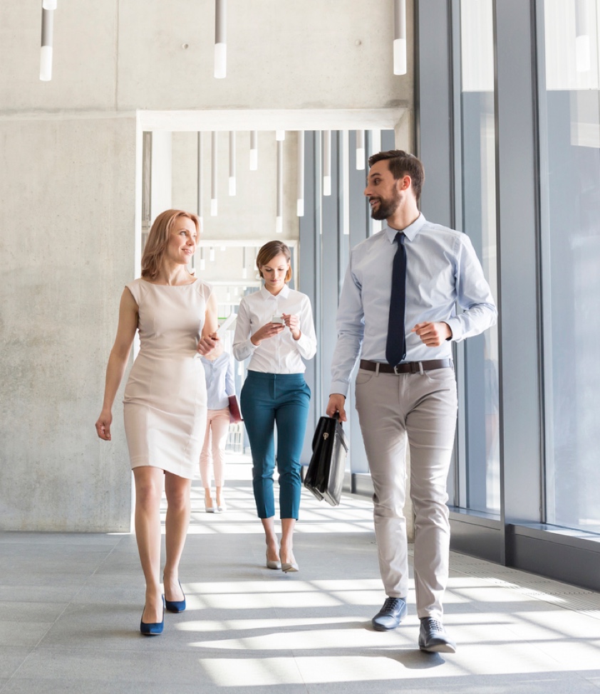 Business people walking in modern glass office building