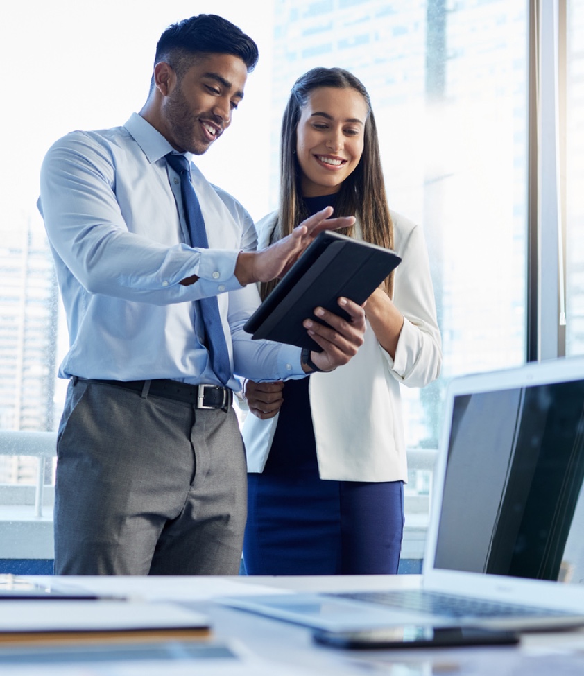 Shot of two businesspeople discussing something on a digital tablet